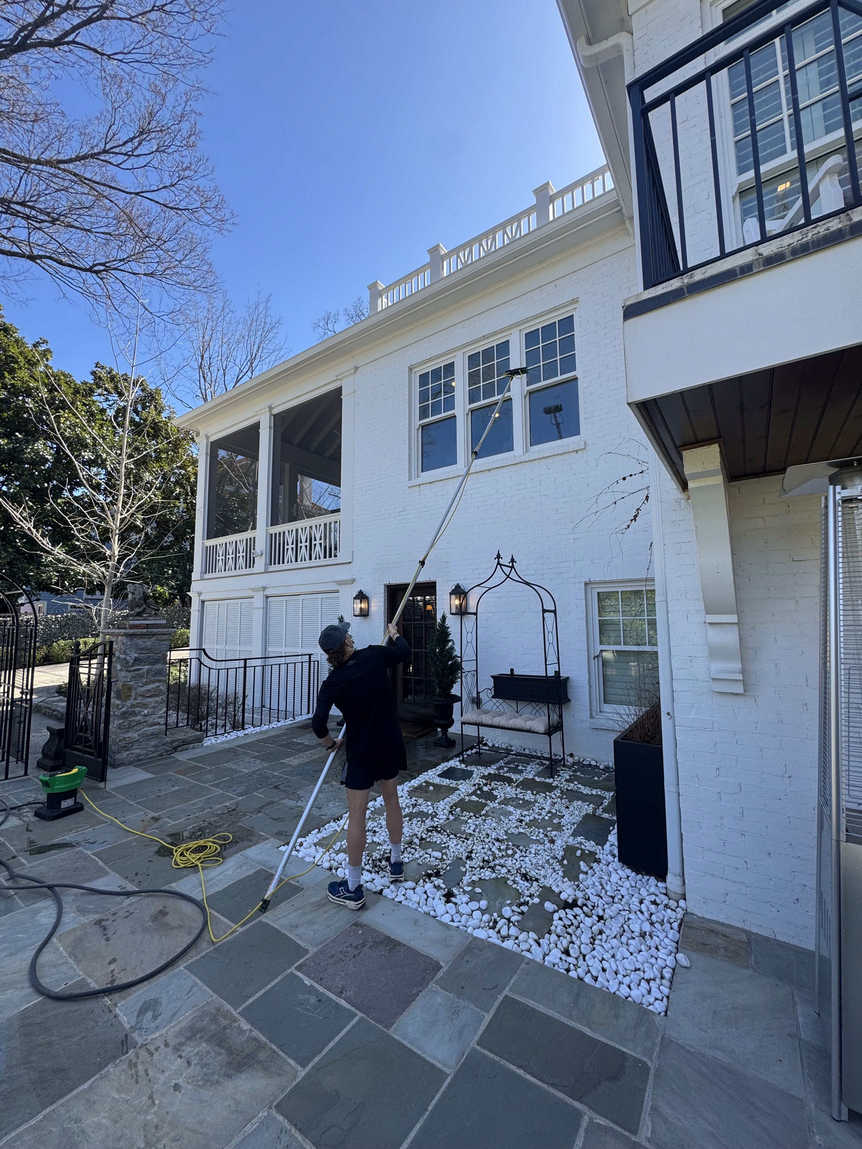 Settle Soltuions' crew cleaning a home's window