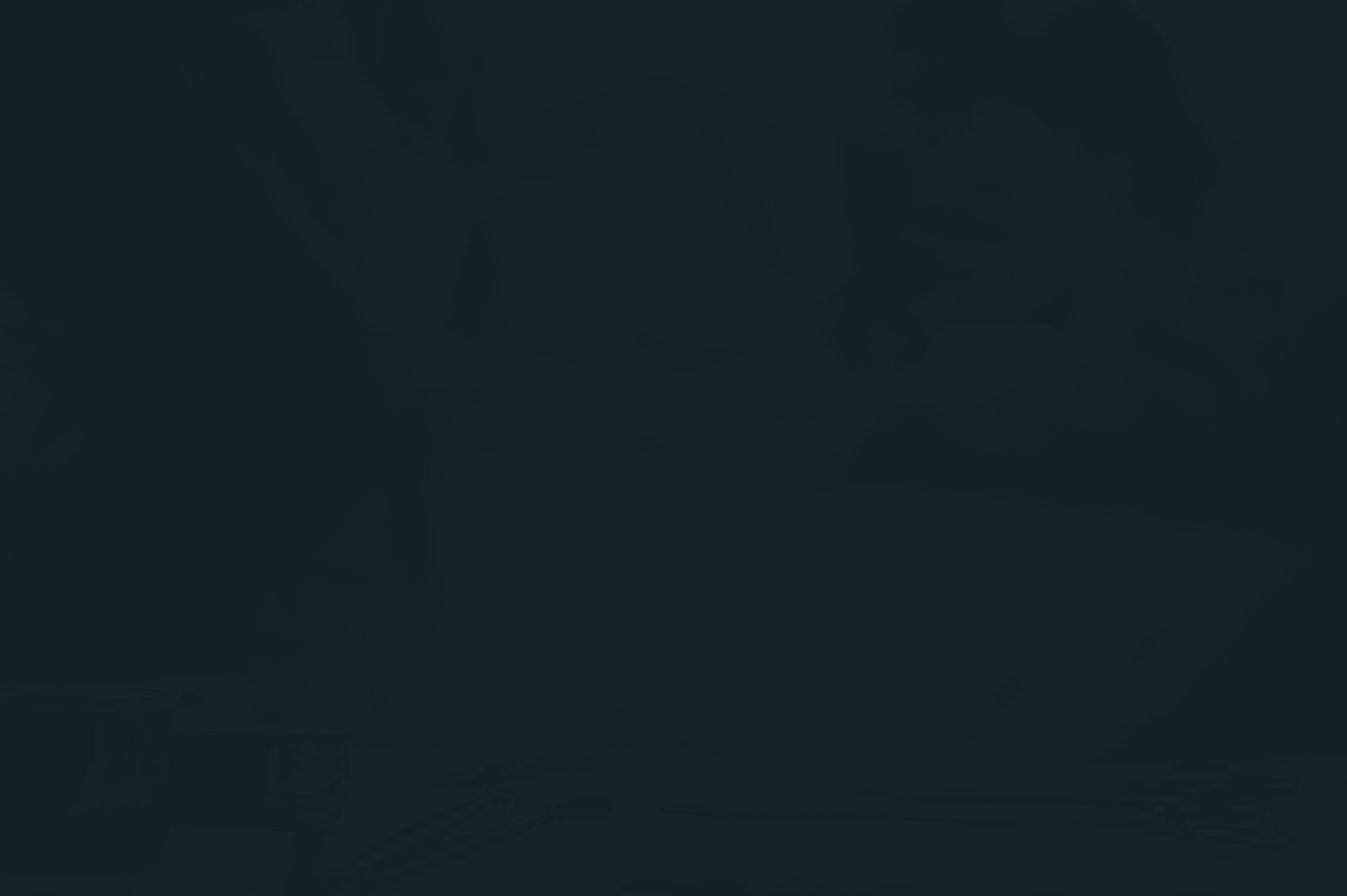 Surgical team in gowns preparing procedure with instruments laid out on table in foreground