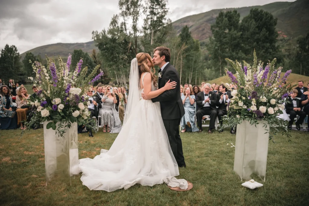 Newlyweds sharing a kiss after ceremony at Aspen Meadows Resort Wedding