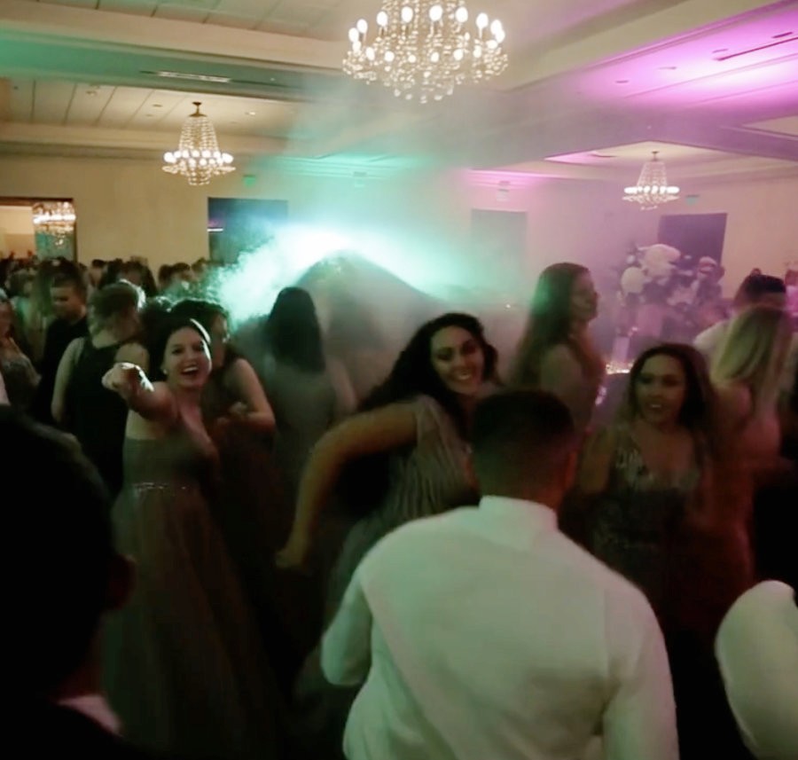 Guests jumping and dancing together during a peak moment