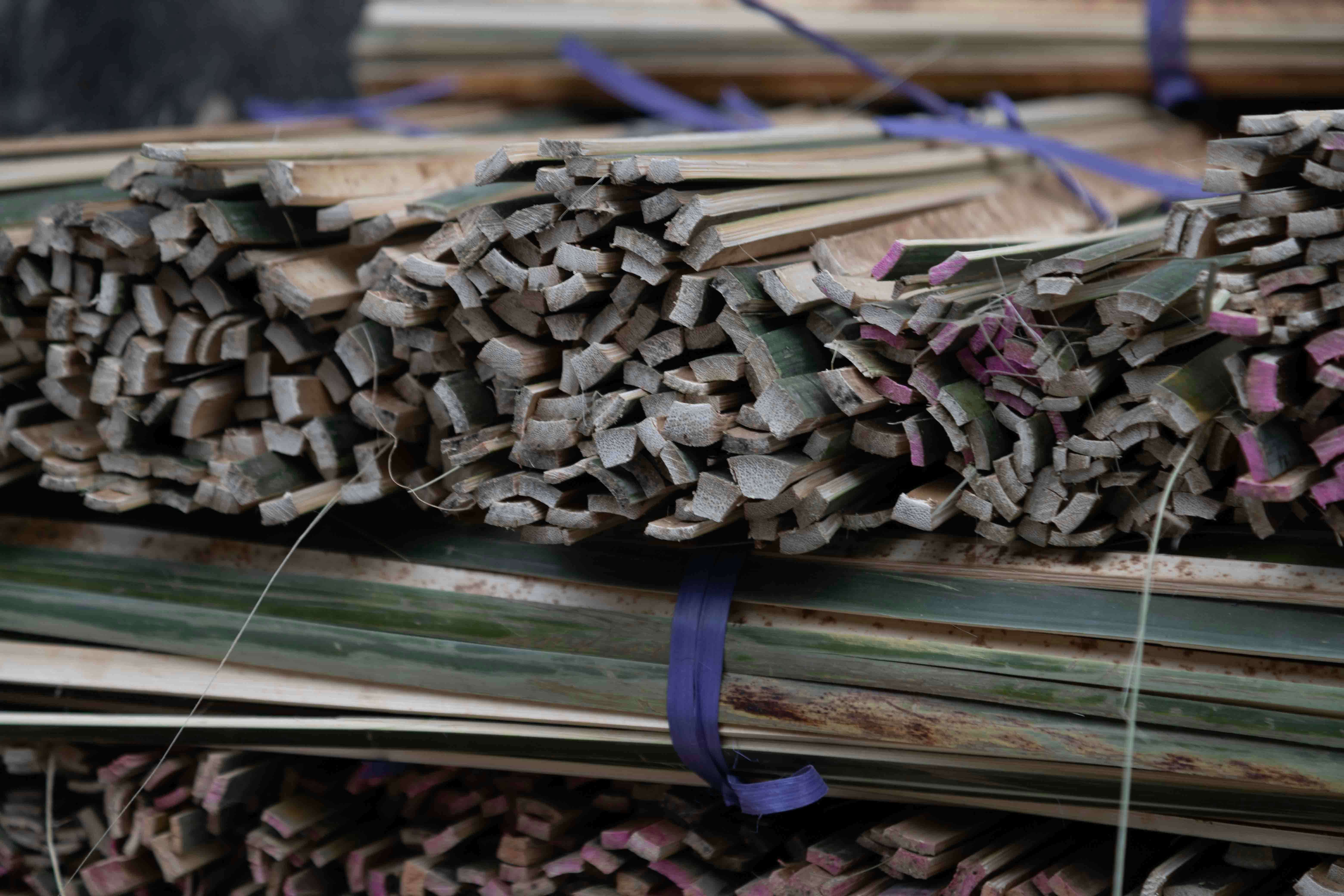 Bundles of dried reeds tied with purple string