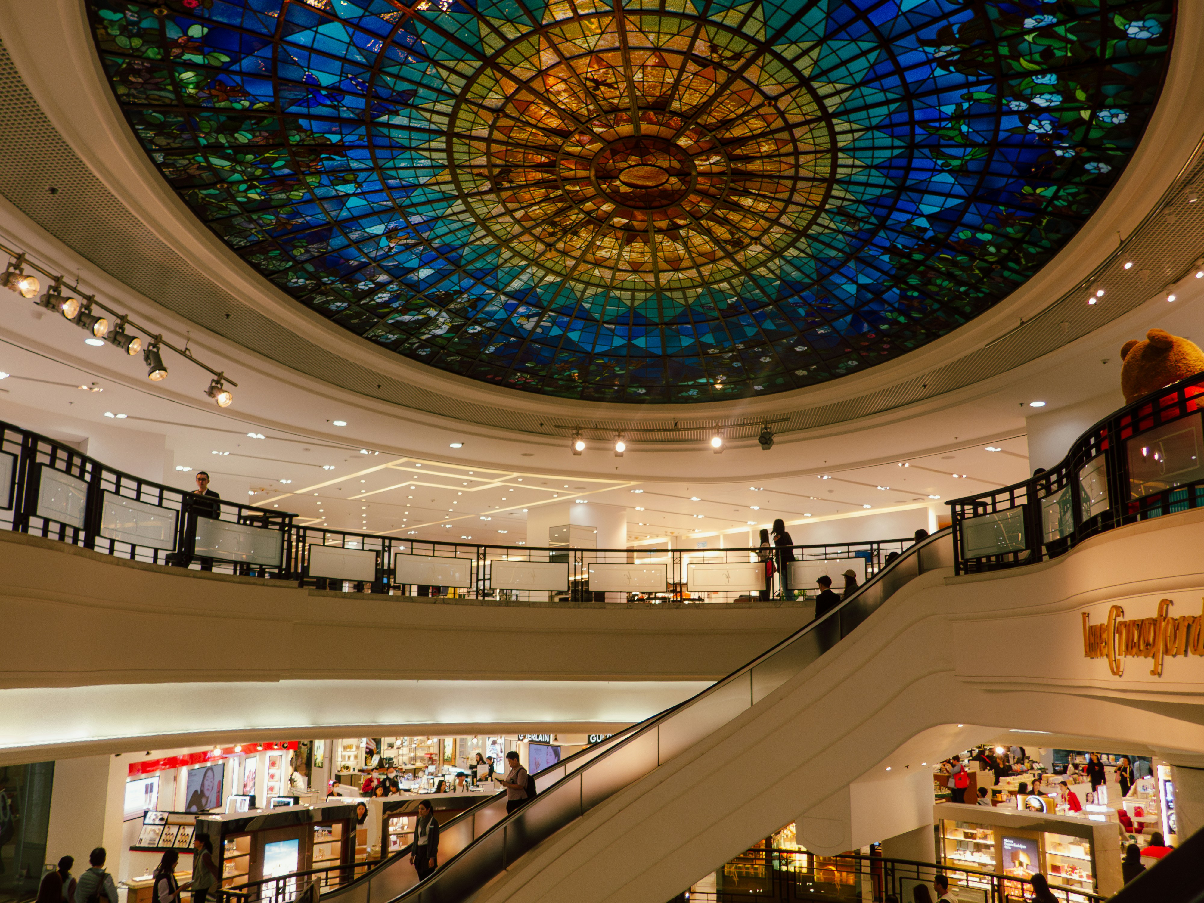 A large shopping mall features a colorful dome.