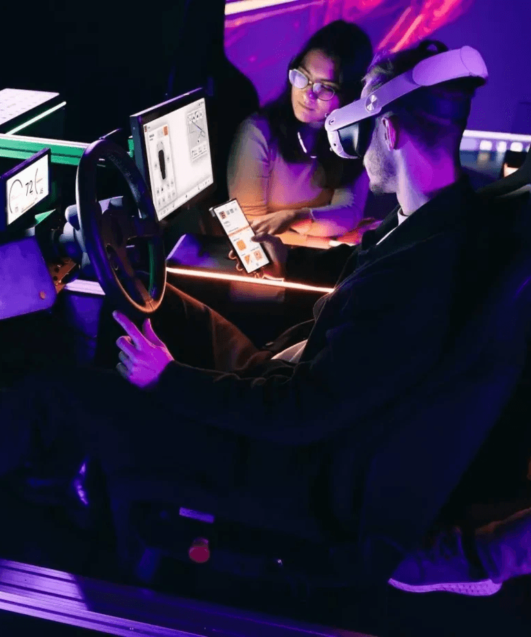 Man in VR headset interacting with a simulation, representing integrated automotive, UX, & industrial design by a multidisciplinary design studio in Turin.