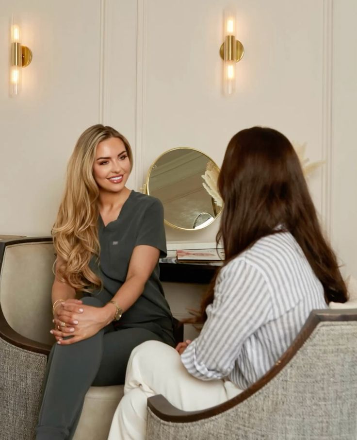 a desk with a chair and a vase of flowers