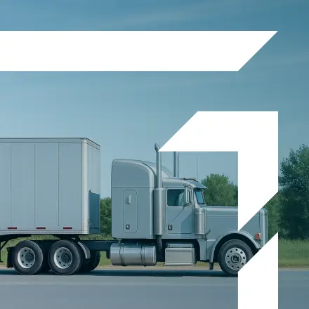 White semi truck under blue sky representing Physical Damage Insurance coverage for commercial trucks.