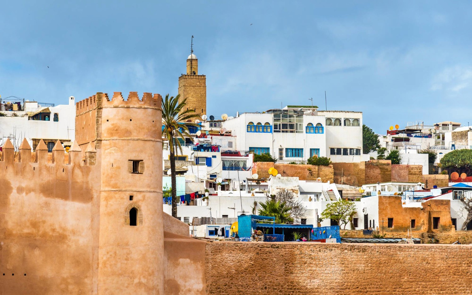 blue and white painted houses on the cliff
