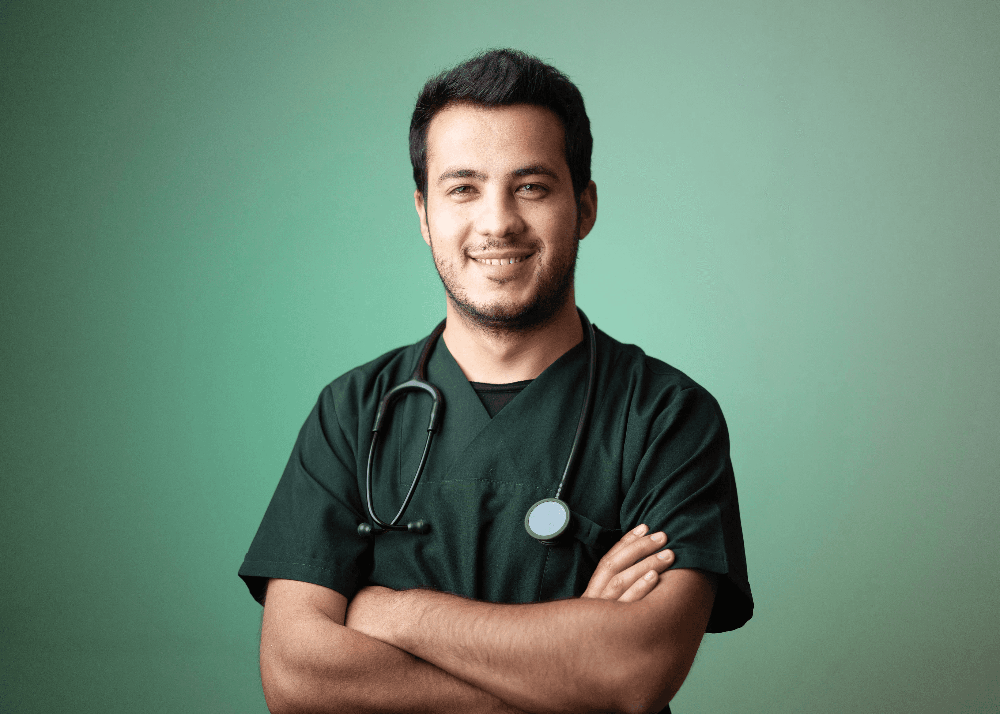 Male doctor in green scrubs with stethoscope