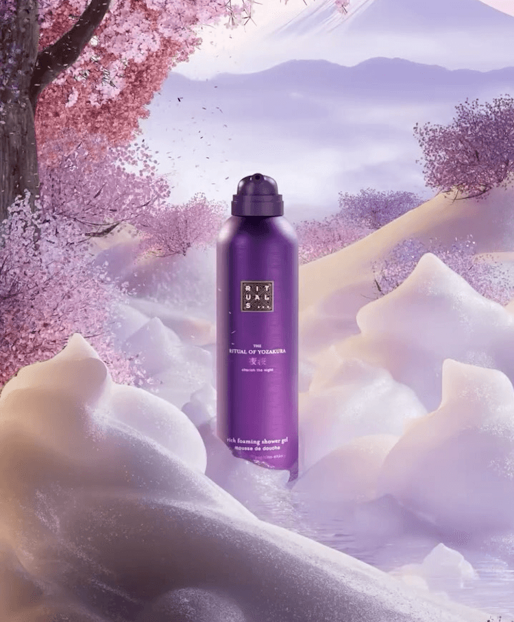 A vibrant promotional image featuring a bottle of 'Ritual of Yozakura' foaming shower gel by Rituals, set against a dreamy backdrop of cherry blossom trees and soft, fluffy clouds.