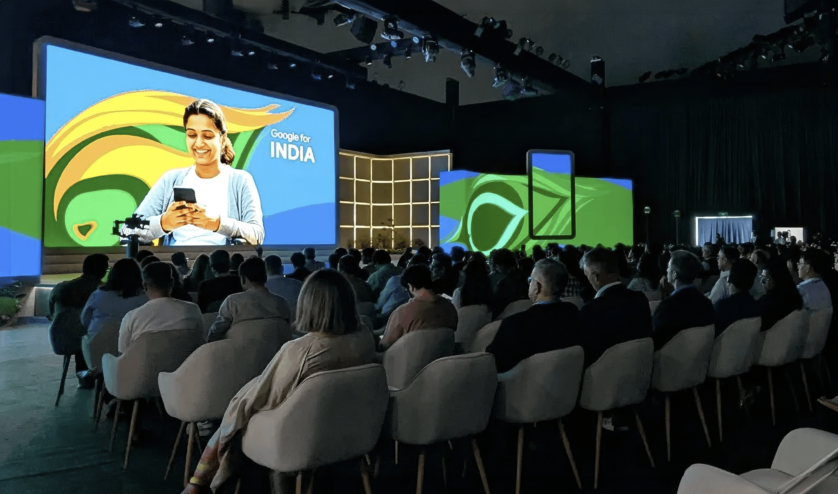 Google for India hero slide featuring a man on his phone against a green background with swirling abstract Google branding