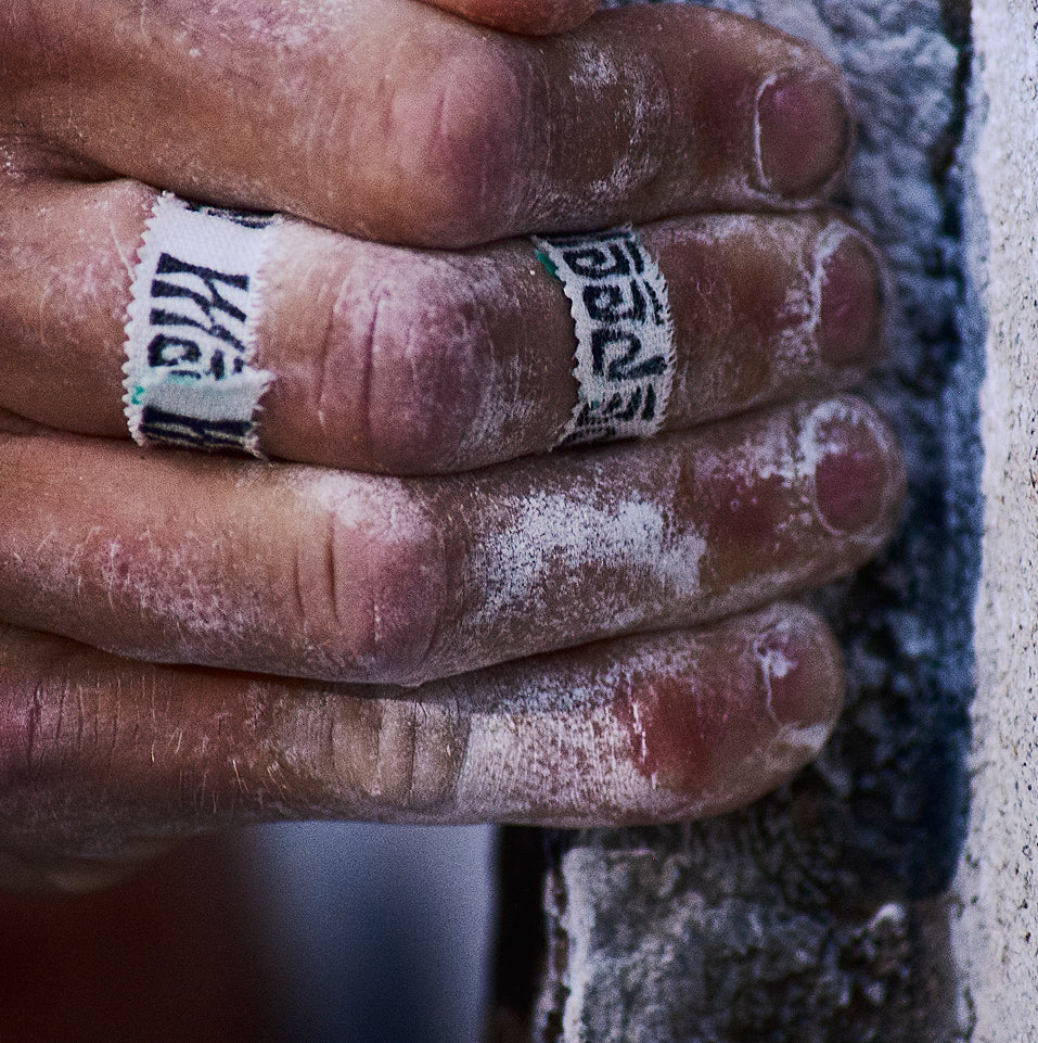 Hand with flour and tape holding a brick