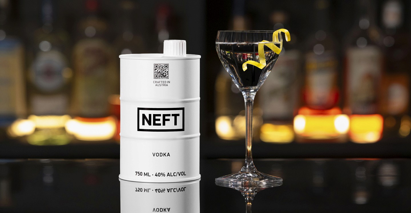 A NEFT Barrel and a glass of Royal 53 on a bar counter.