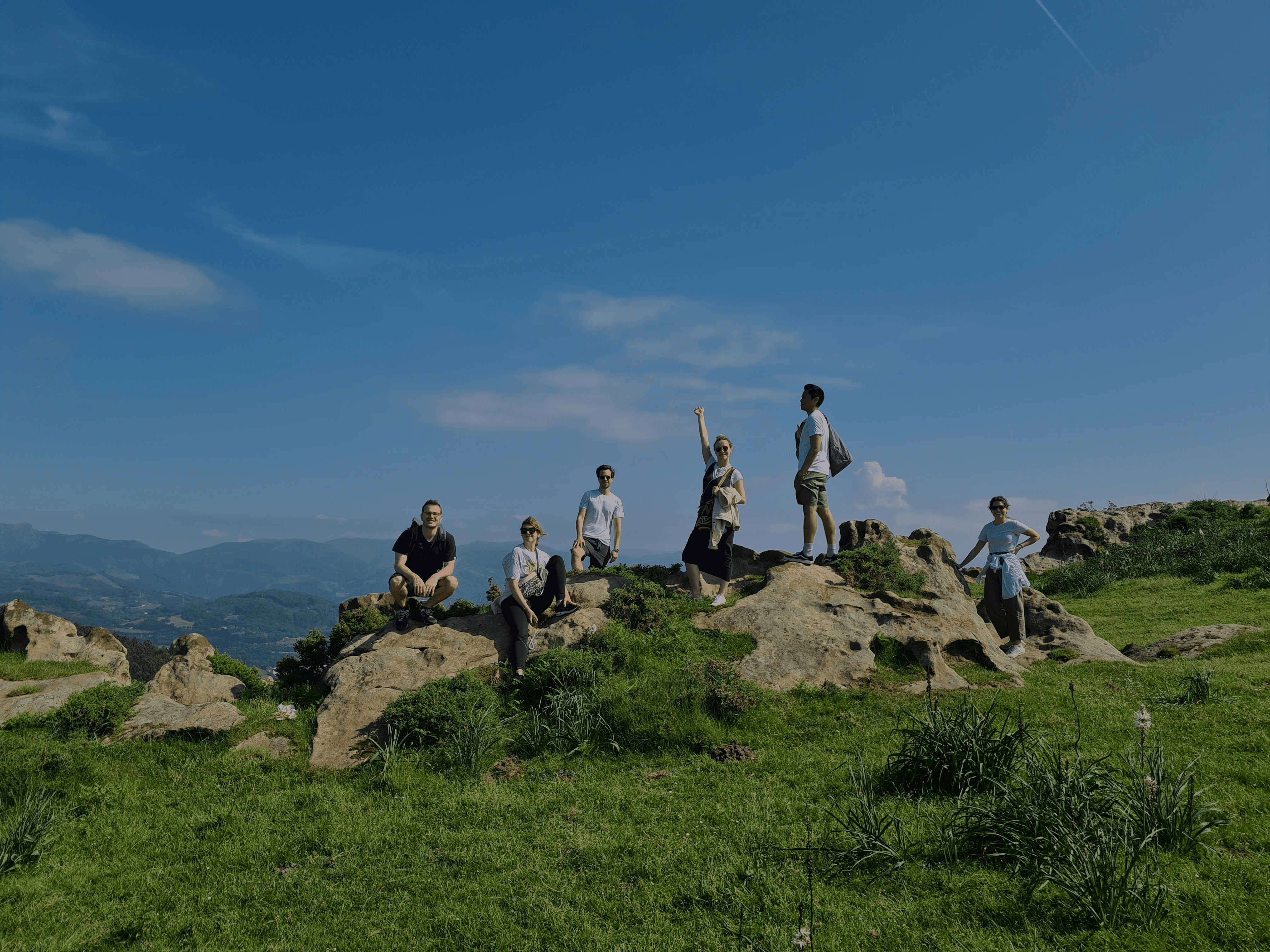 Panoramic view of San Sebastian, Spain. The city is nestled between two hills and a beautiful bay filled with boats.