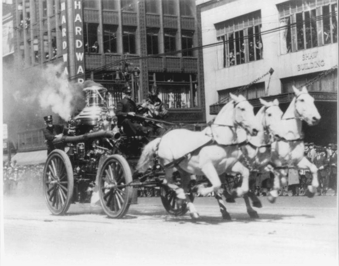 Steam powered fire fighting wagon pulled by a team of firehorses.