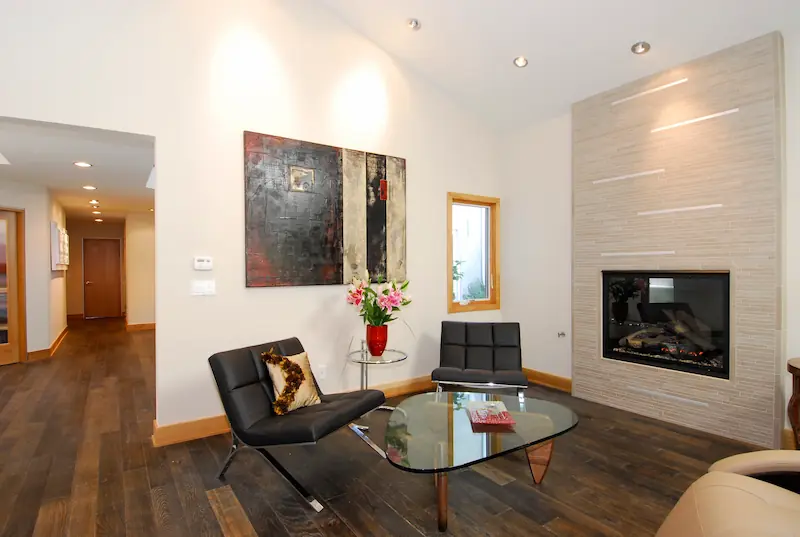 Cozy seating by a modern fireplace with art decor, hardwood floors, Irvine Transitional Modern, photo by Chris Darnall.