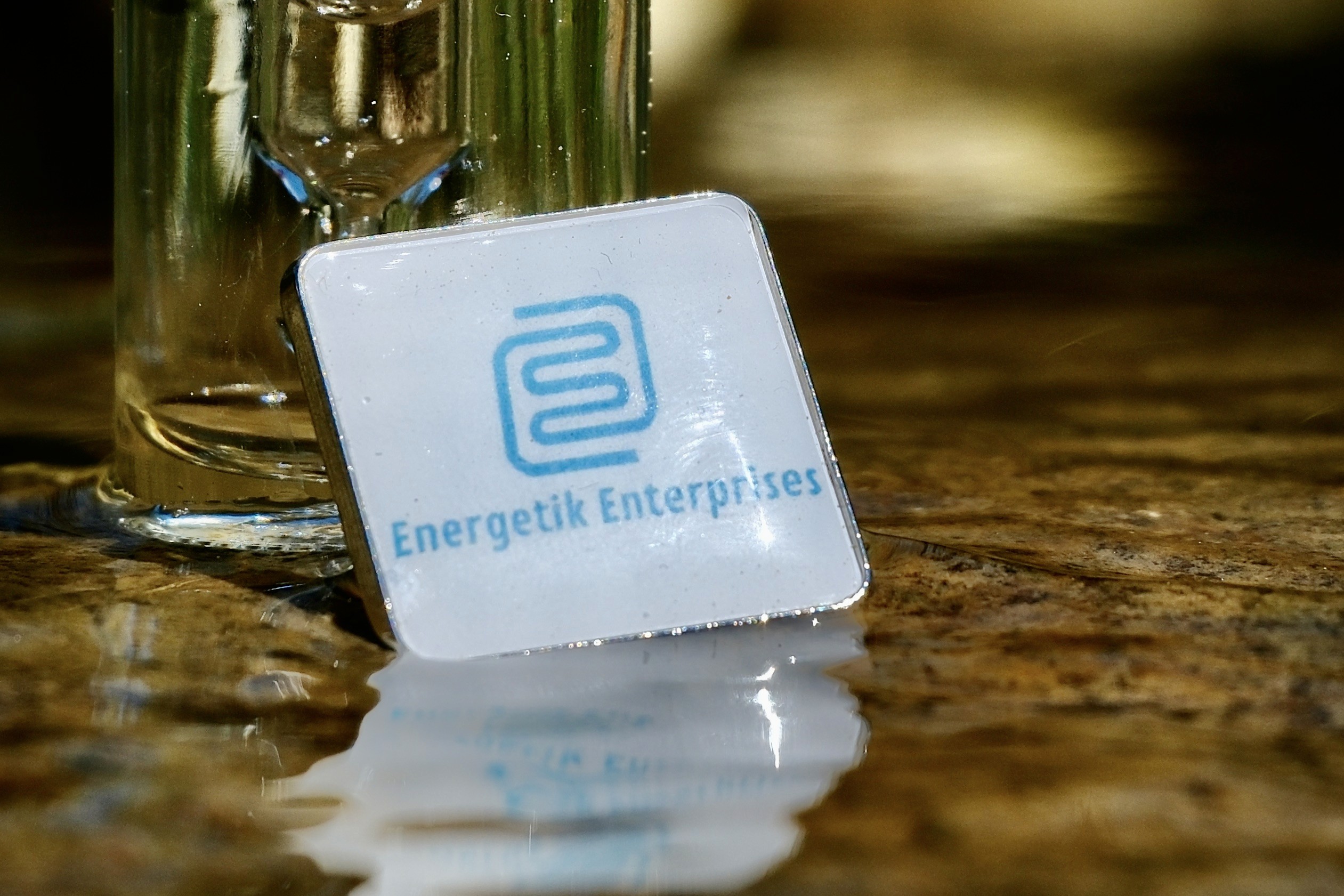 A person lying on a massage table, their face covered with a towel, bathed in warm golden light. The setting exudes relaxation and comfort.
