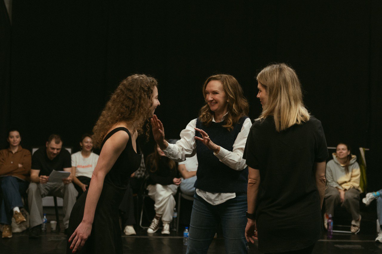 woman sitting around table holding tablet