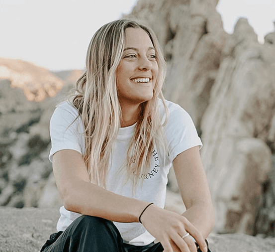 Woman sitting down on a hiking trail
