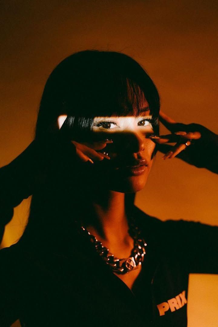 Women in front of an orange background