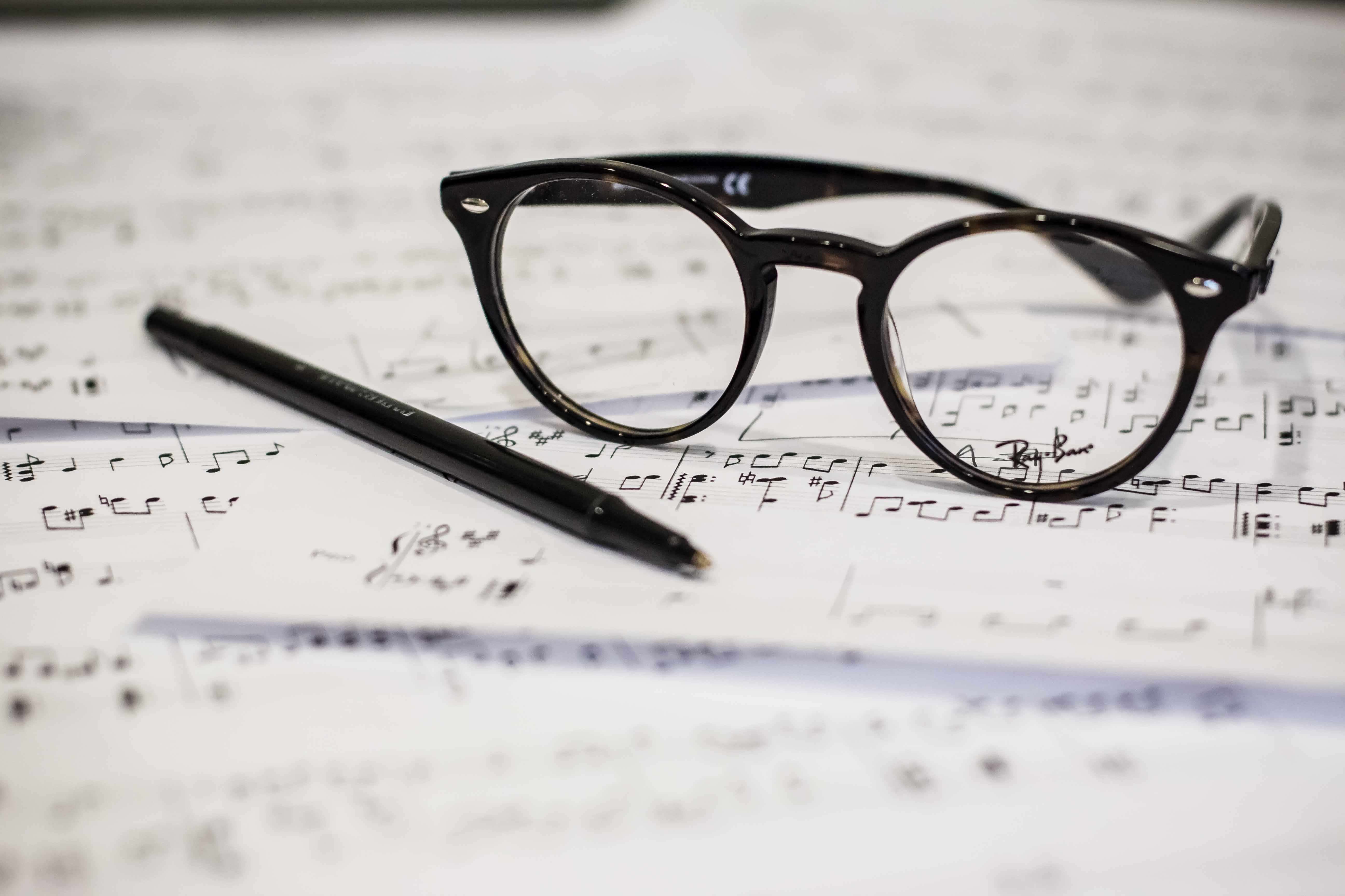 glasses on pages of music notes - how to write a good song