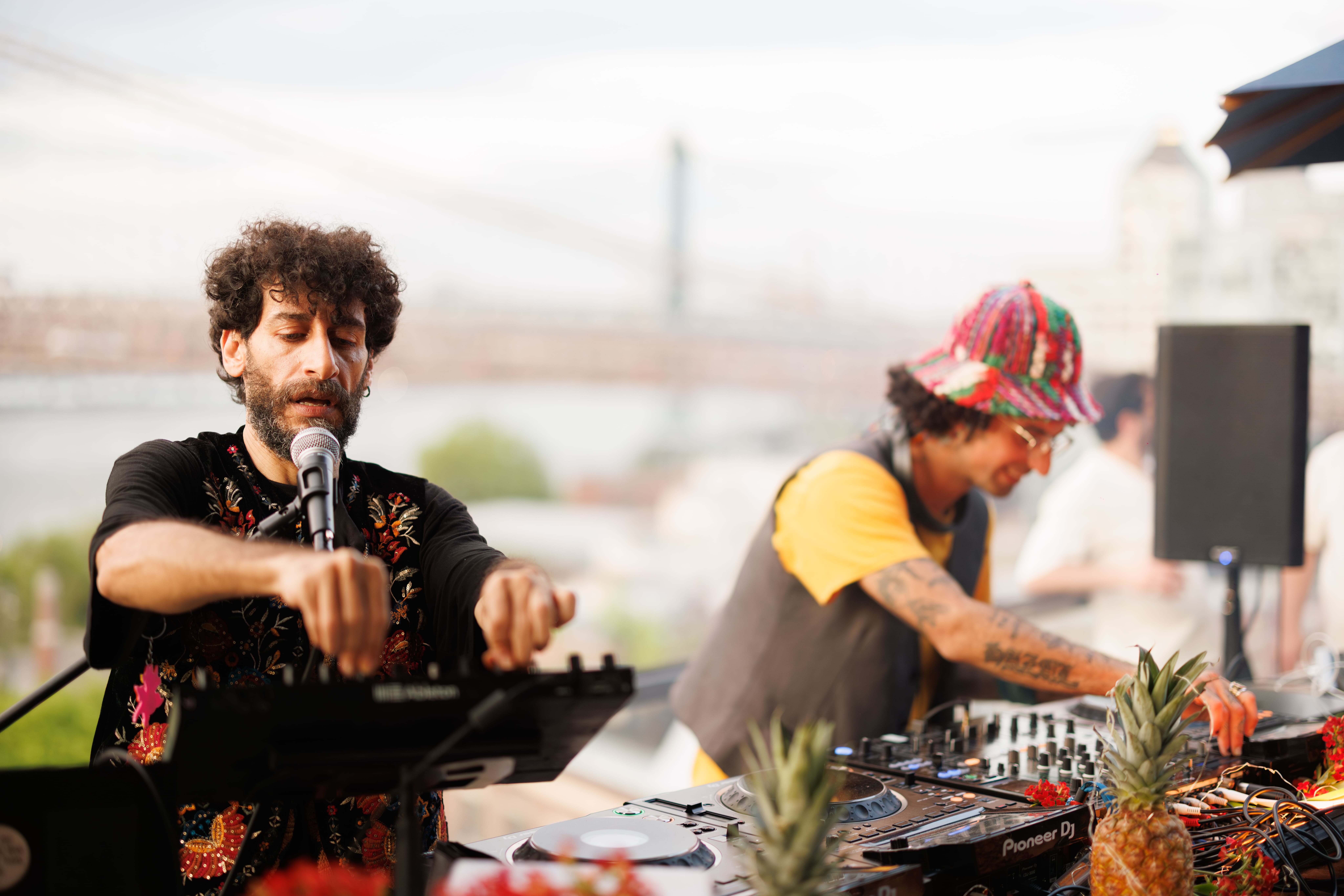 Full moon rising over a dark, silhouetted mountain ridge.