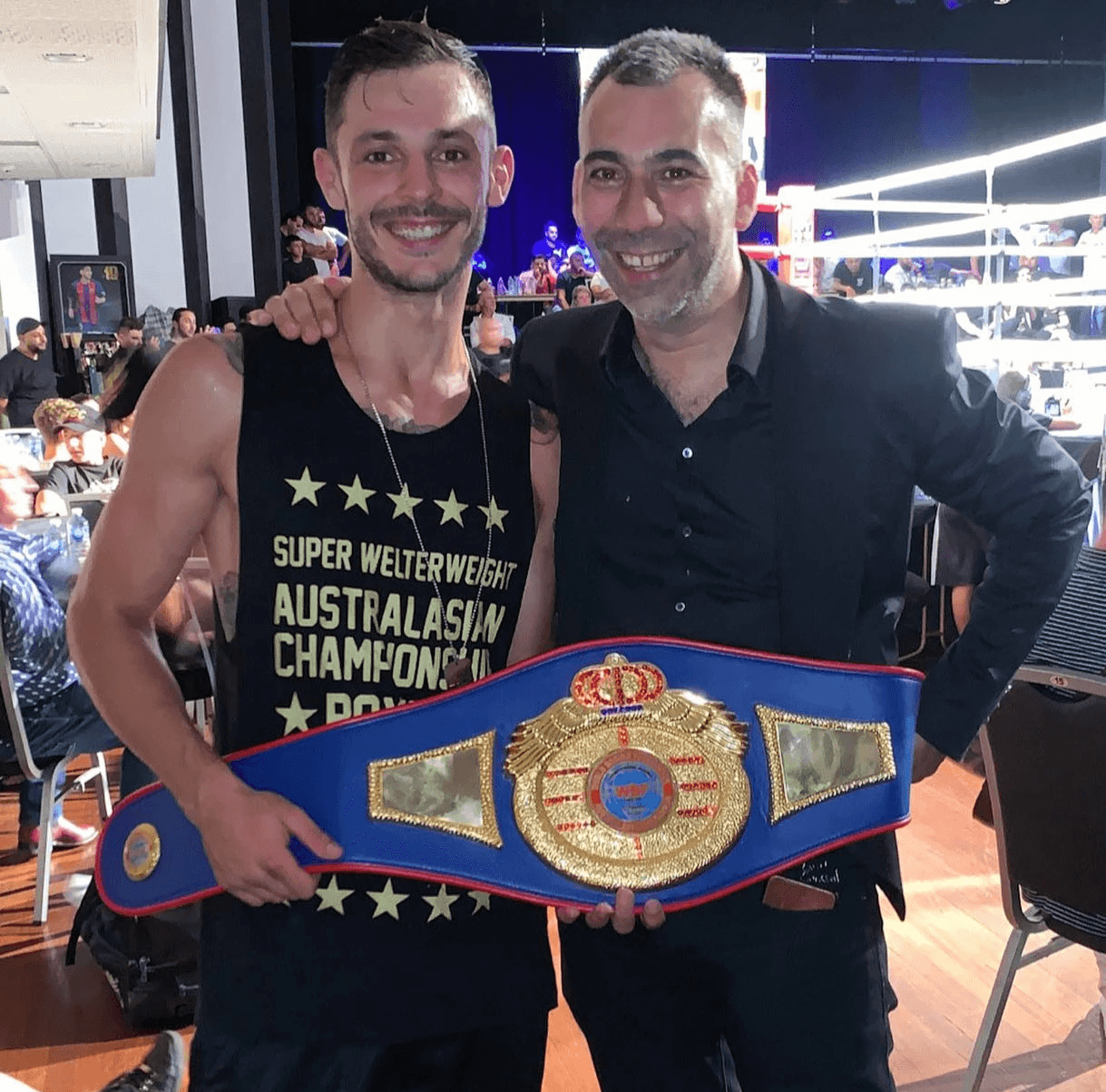 Danilo Dash Creati posing with a championship belt after winning a title fight.