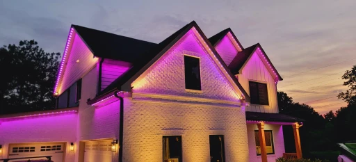 Residential Christmas lighting service with red accents and roofline lights in Chester County, PA, creating a bold holiday display.