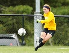 photo of a girl kicking a soccer ball