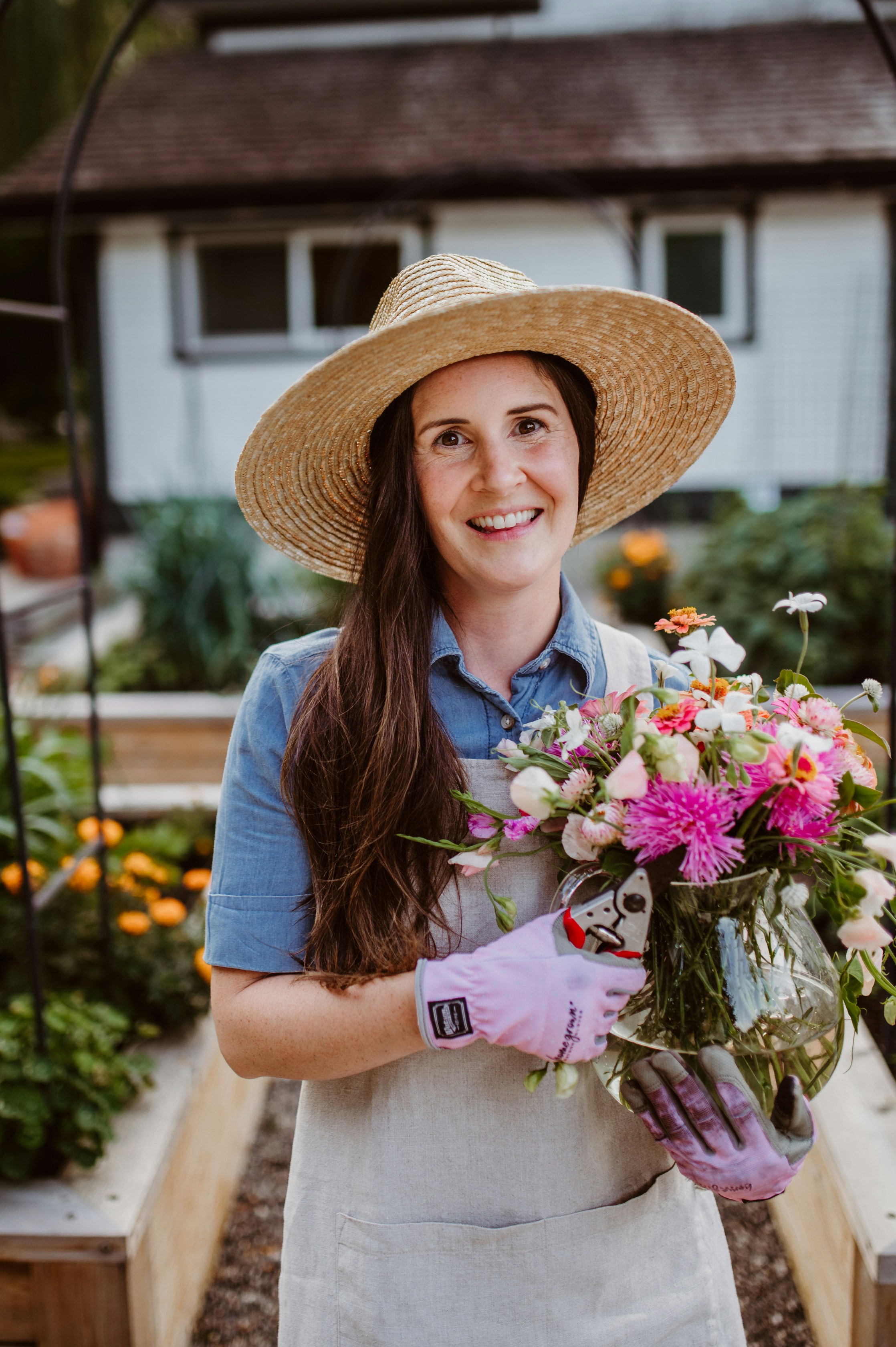 A woman holding a bouquet of flowers in a garden