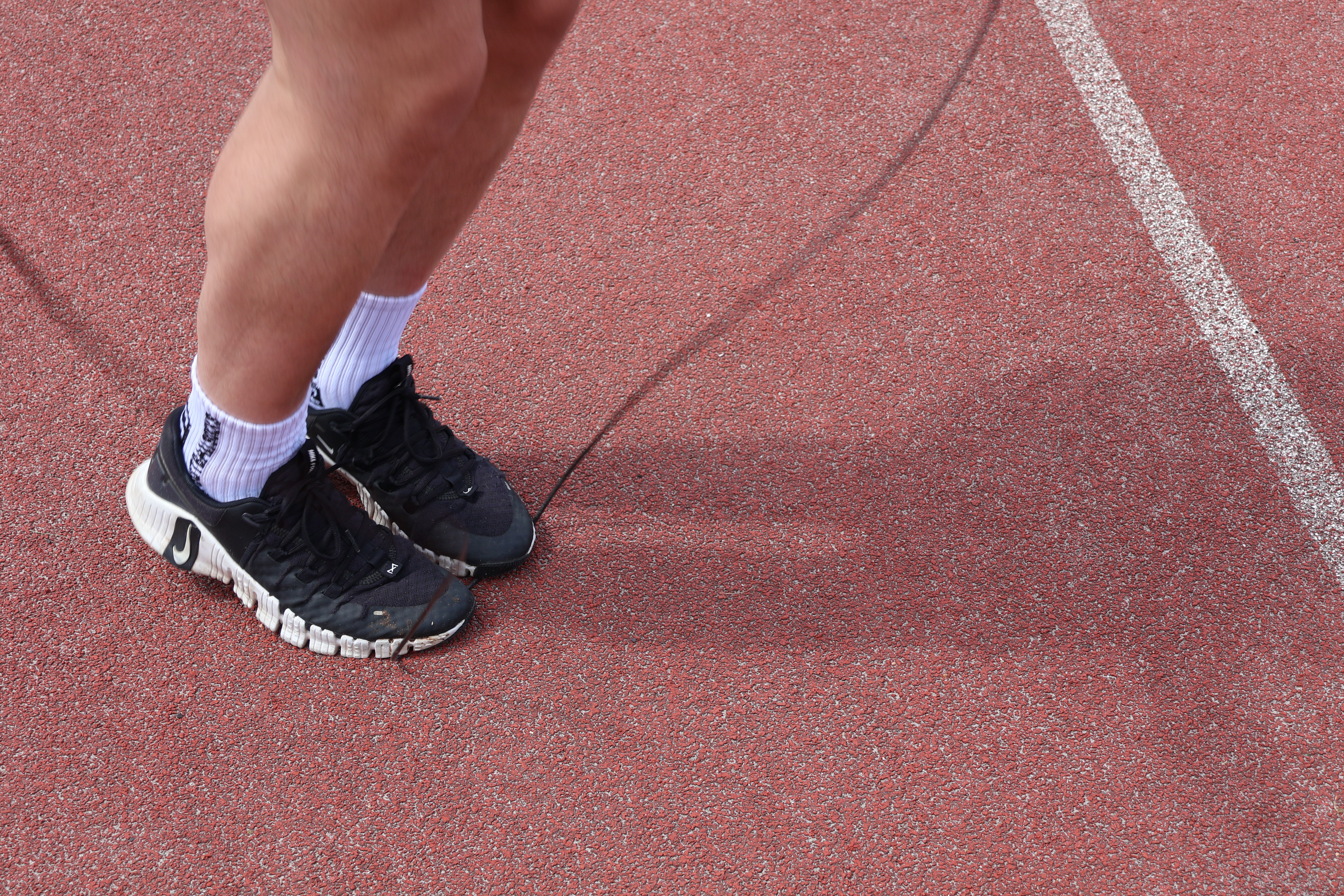 Runners legs in motion on asphalt. Running shoes and healthy legs.