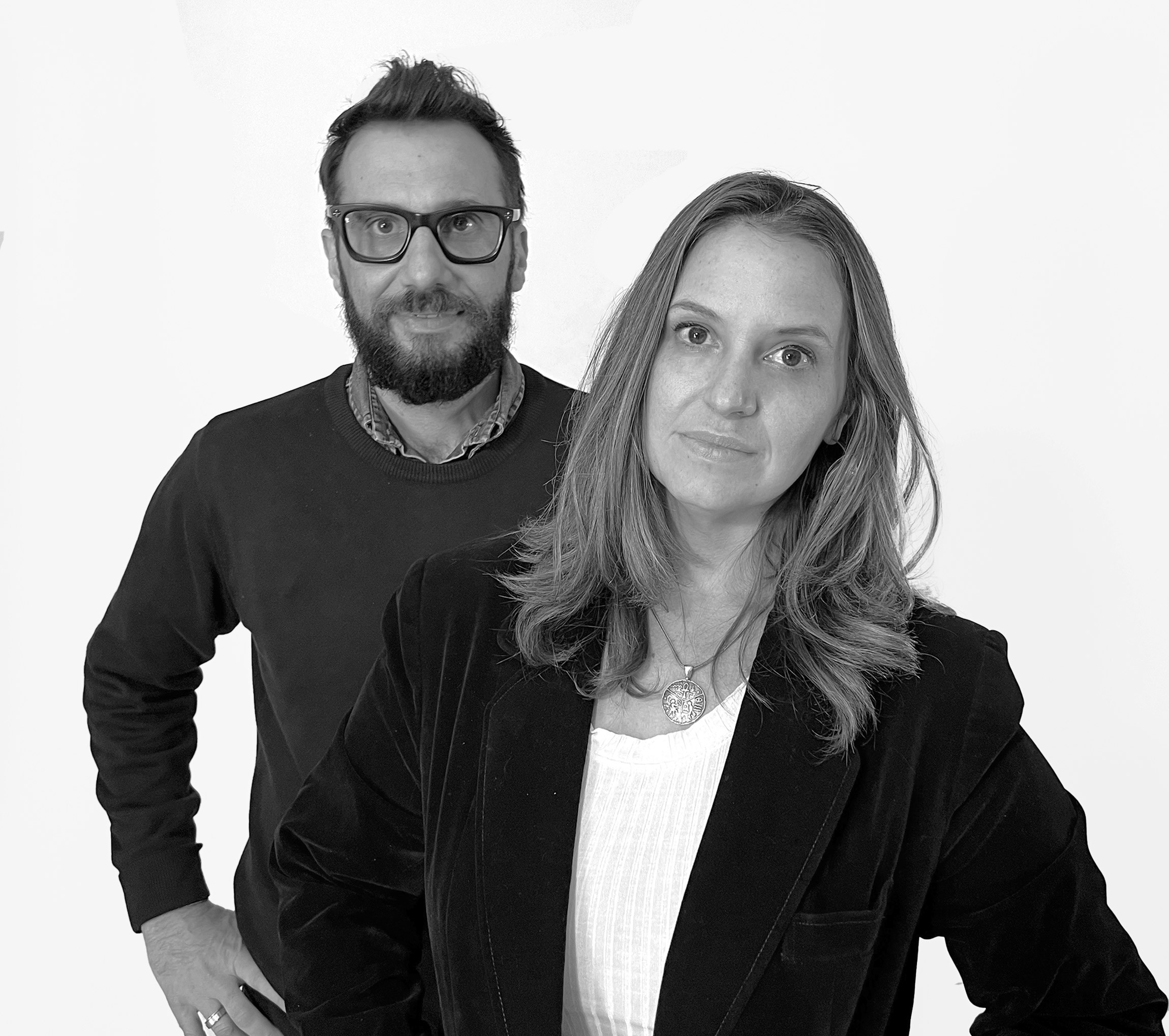 Monochrome product shot: black-capped cosmetic bottle with dynamic water splash on a clean white background.
