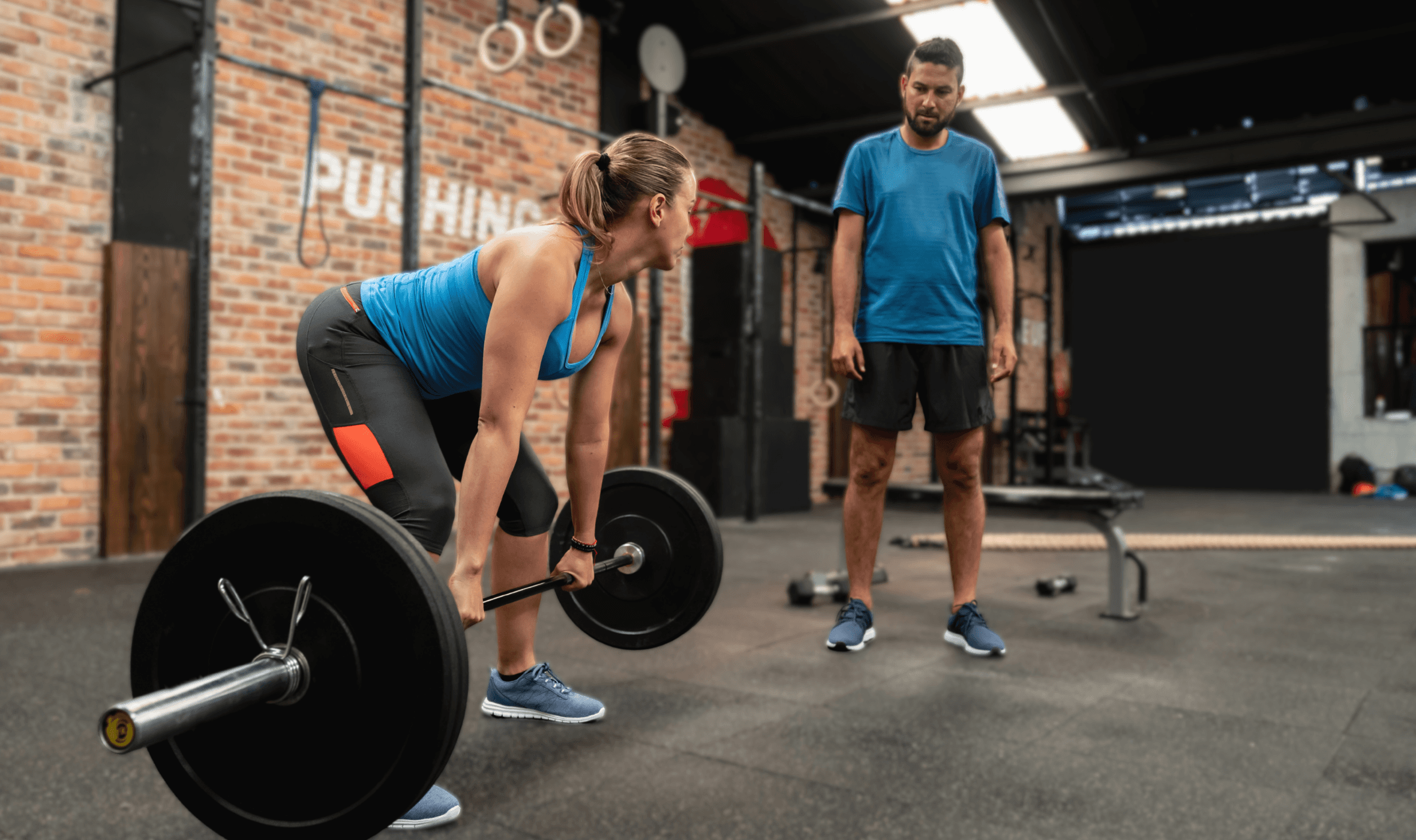 trainee personal trainer providing guidance to another delegate