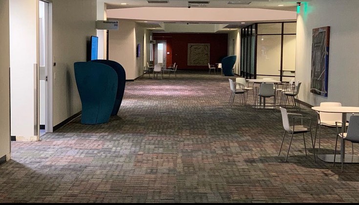Completed office lounge floor in patterned carpet tile with seating in place
