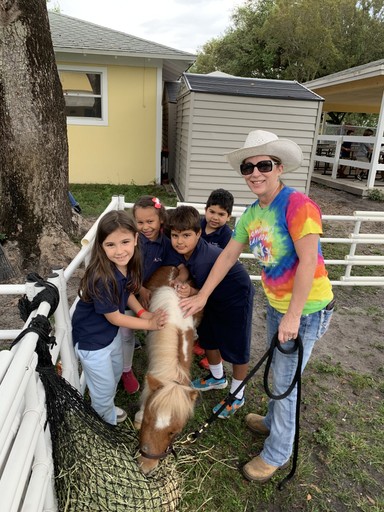 children and a mini horse at a grief on the go! program event