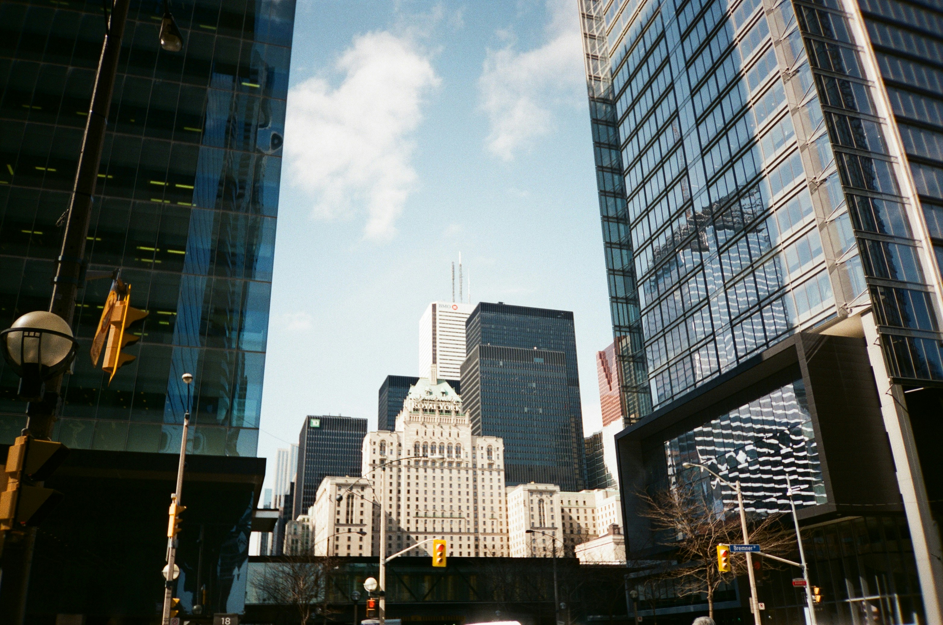 a city street with tall buildings in the background
