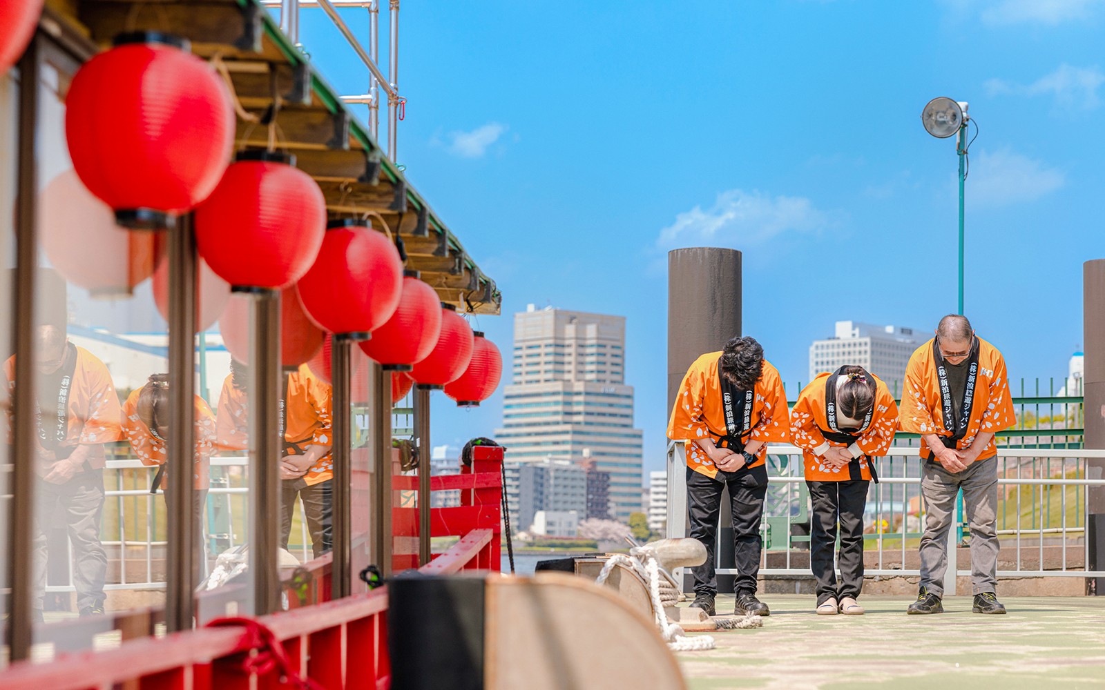 Tourists listening to bilingual guide on a bus tour in a city.
