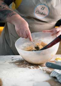 Baker mixing dough in kitchen