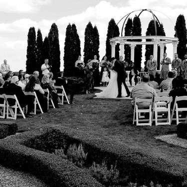 An outdoor wedding ceremony in Chatham, Ontario, set against a picturesque natural backdrop, with guests gathered to celebrate the couple's special day.