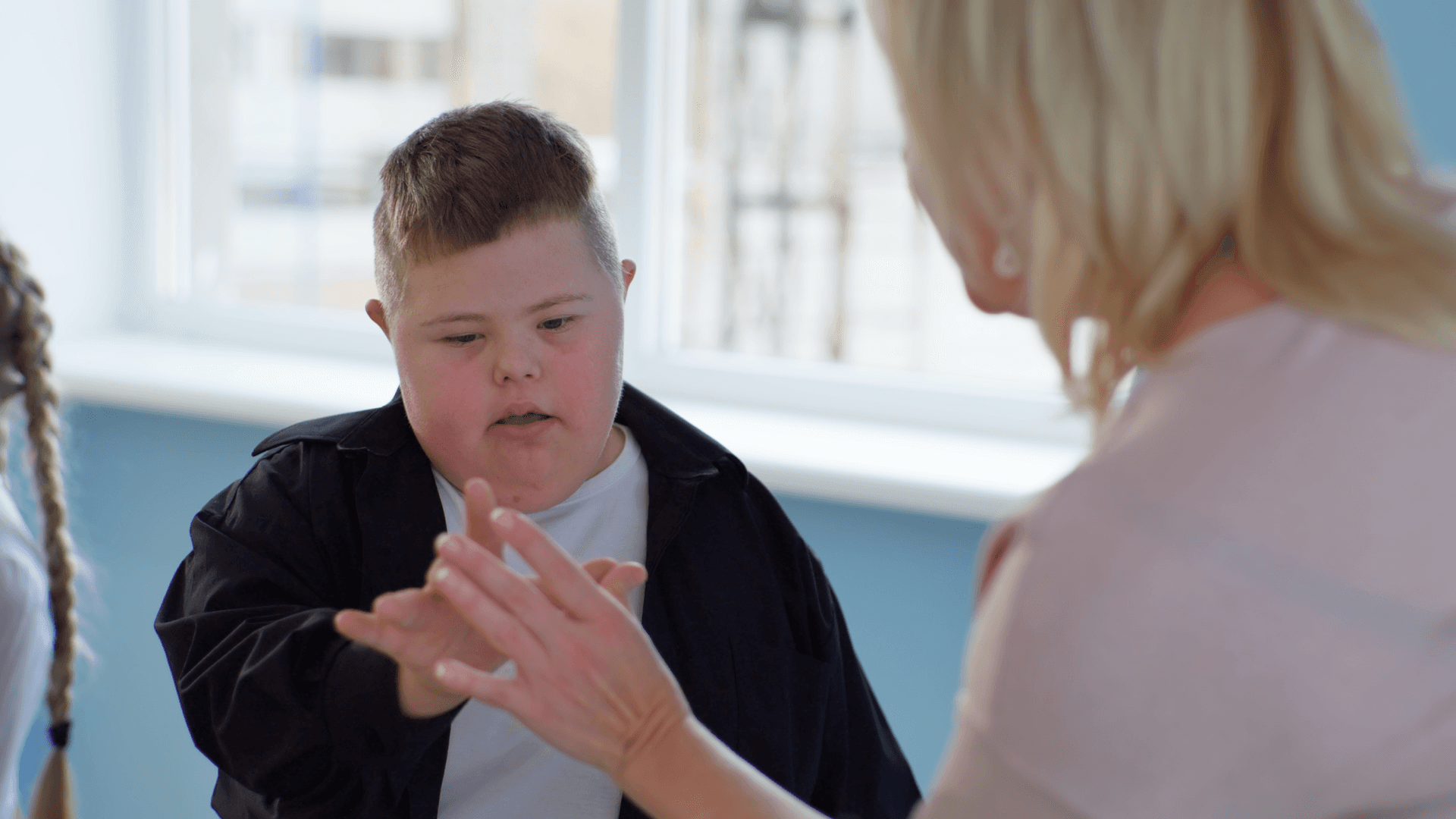 Boy with down syndrome playing a game.