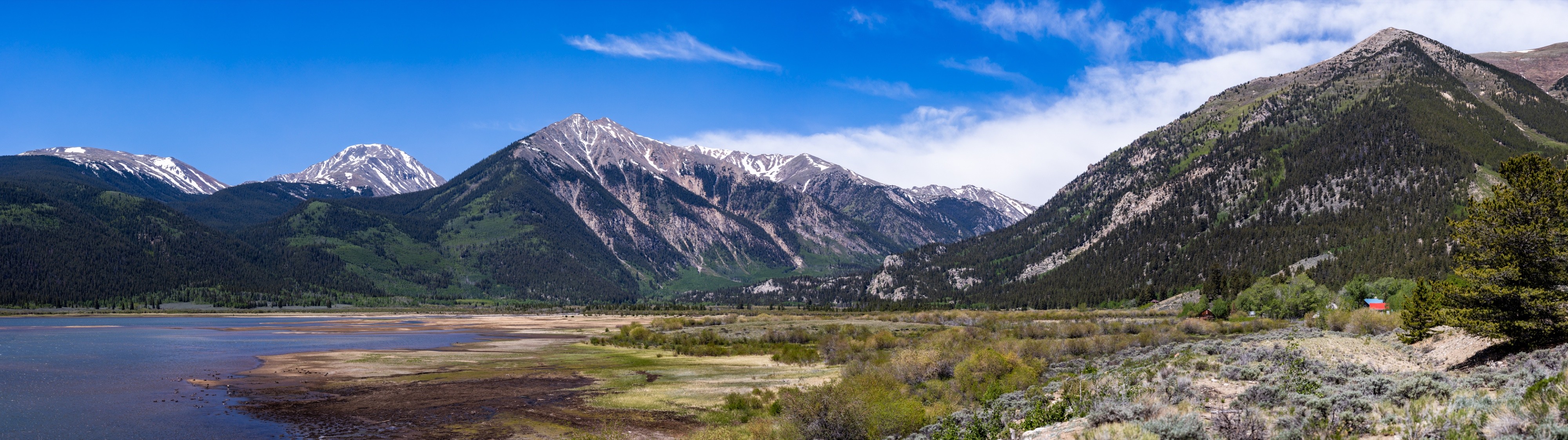 Wide panorama of Twin Lakes beneath snow-streaked Colorado mountain peaks