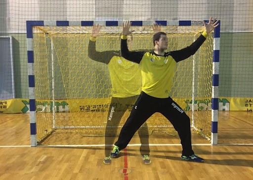 Close-up of lush, dark green leaves, some glossy and wet, against a muted background.