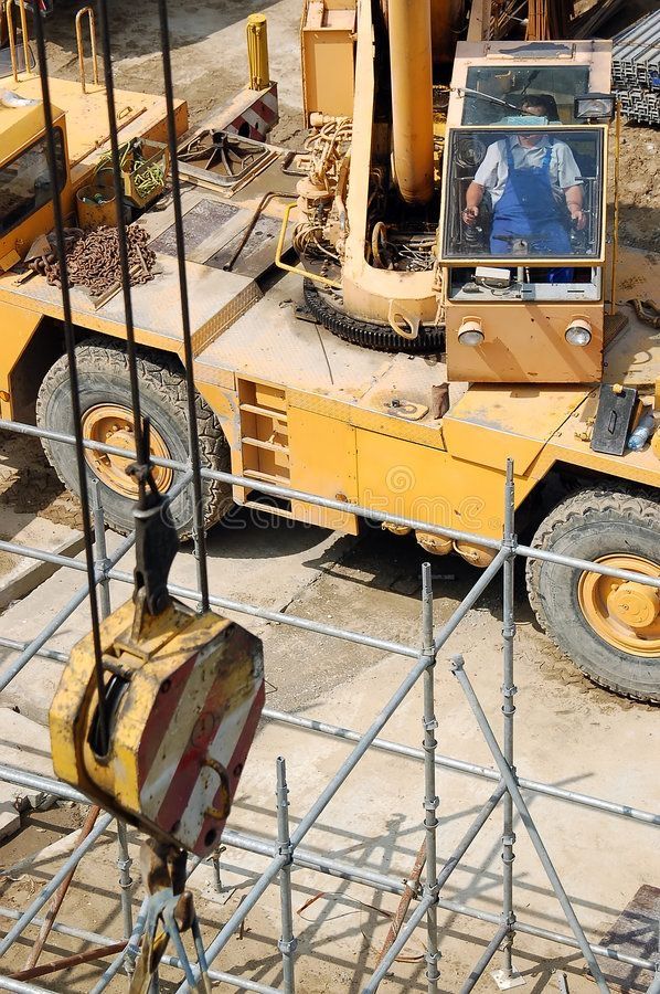 a crane operator in a mobile yellow crane