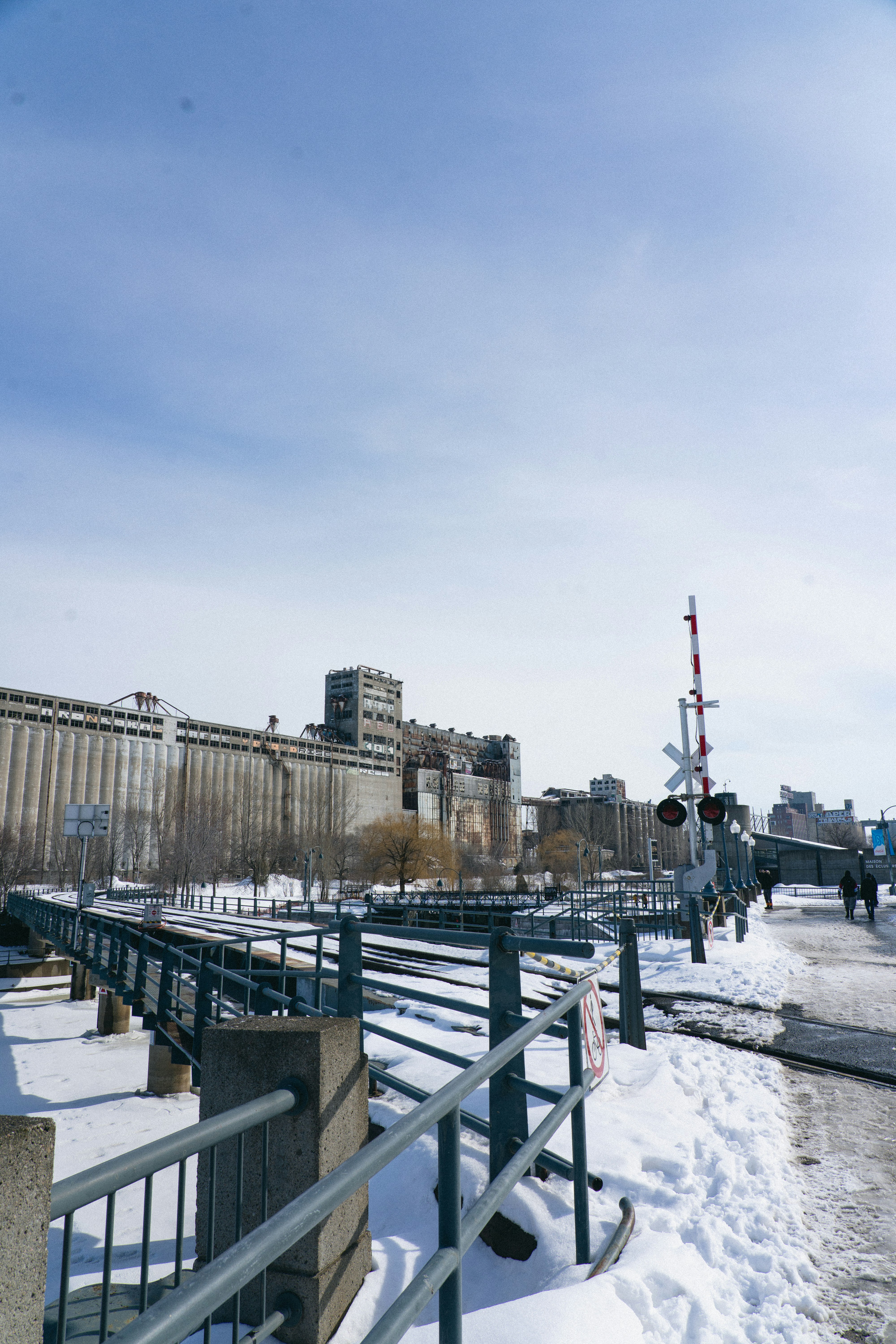 a fence that is next to a building in the snow
