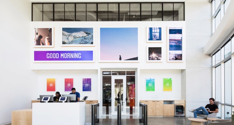 reception desk area with illustrations and photos installed on the wall with many landscapes