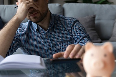 Close-up of lush, dark green leaves, some glossy and wet, against a muted background.