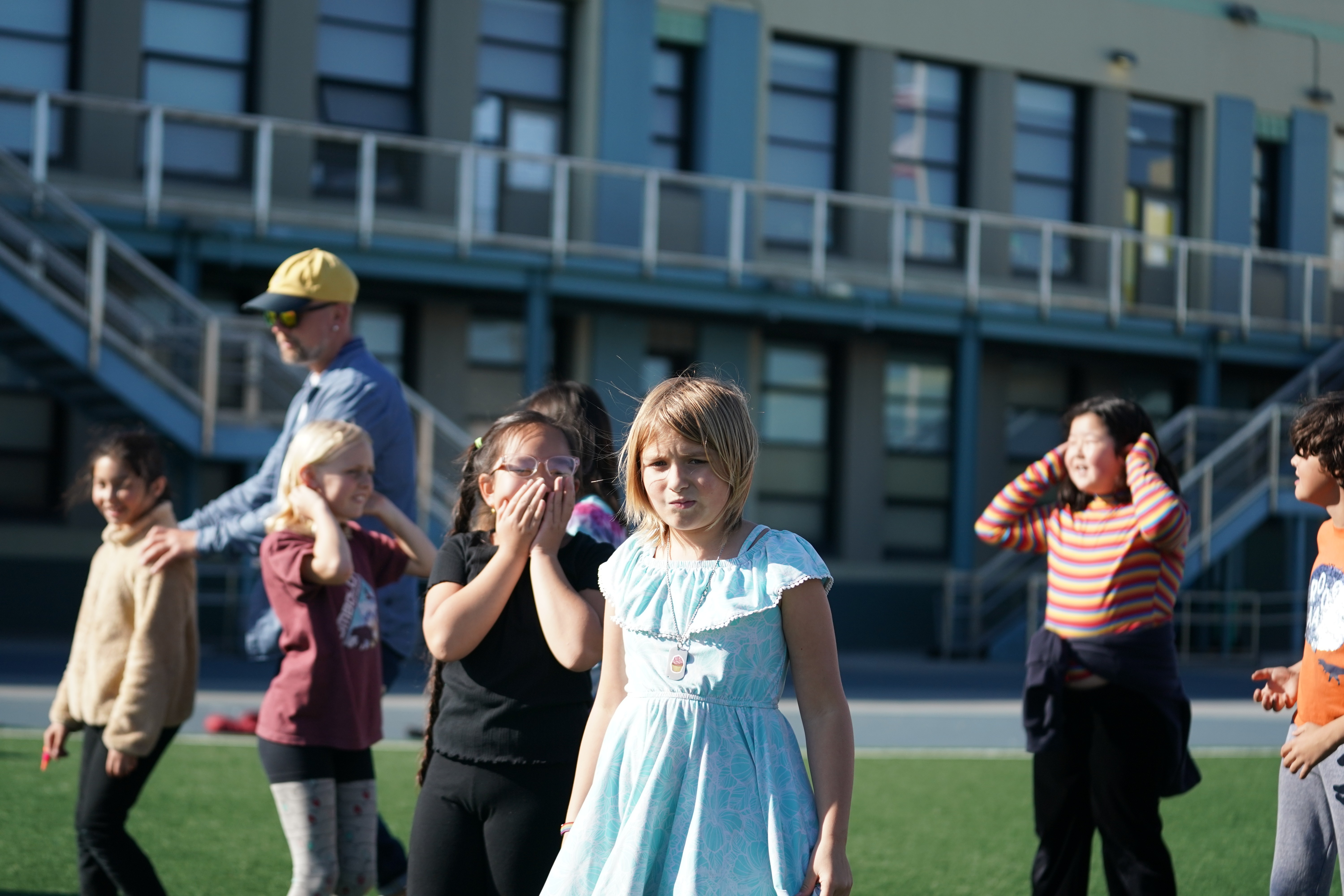 Kids learning synchronized K-pop dance routines in school-based performing arts class