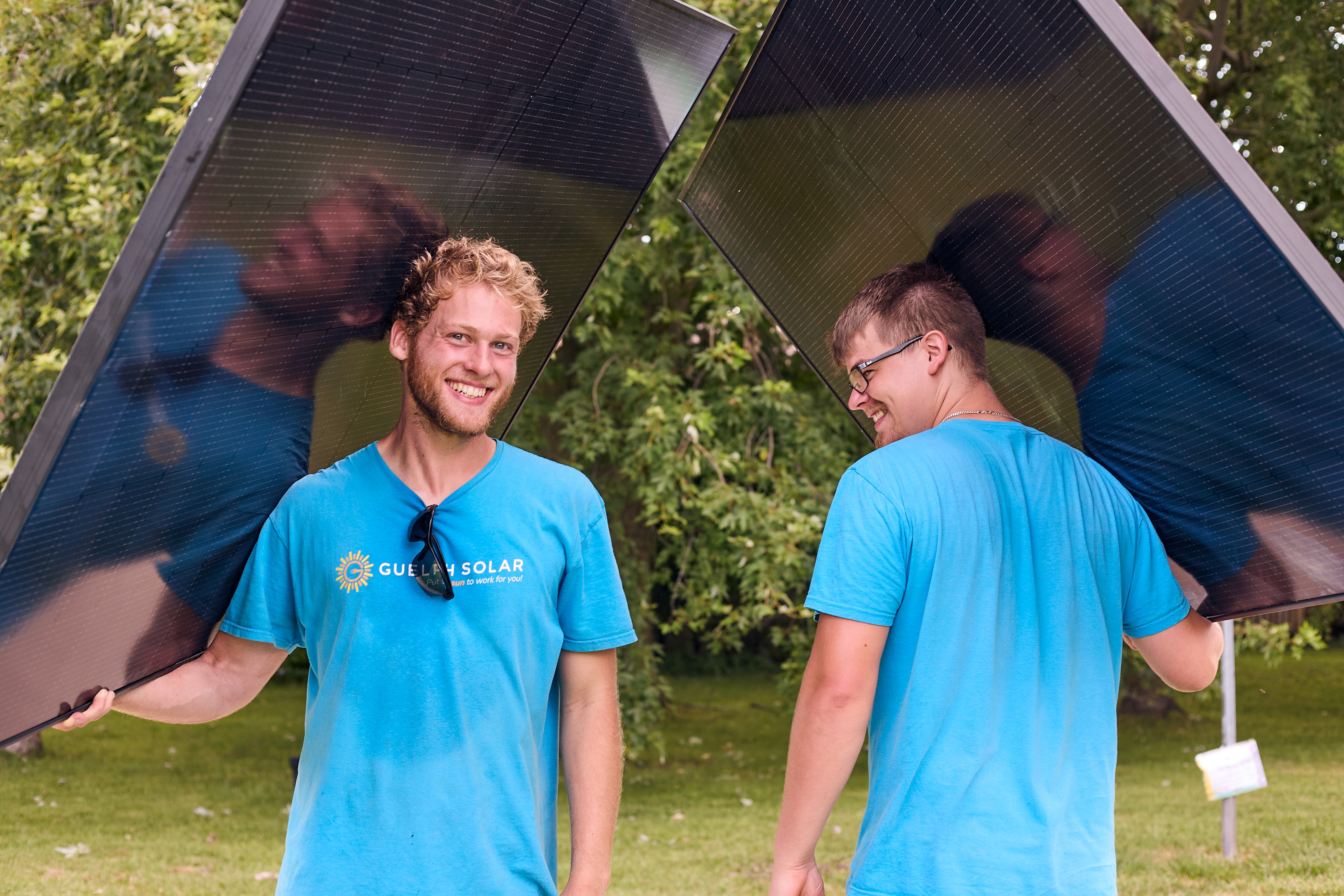 A man wearing grey suit, making eye contact proudly.