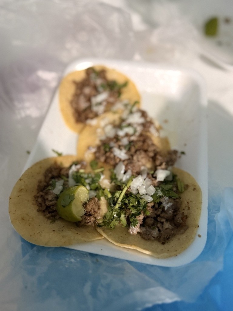 Street tacos in a foam tray bought from a roadside stand in Mexico.