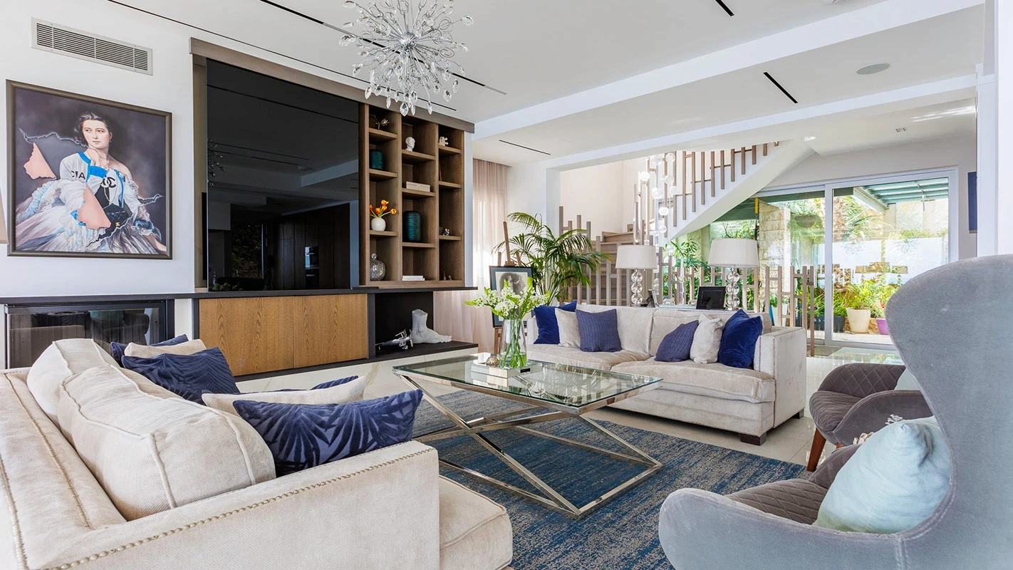 Seafront Residence Limassol living room with blue accents, bespoke media wall, and contemporary lounge seating
