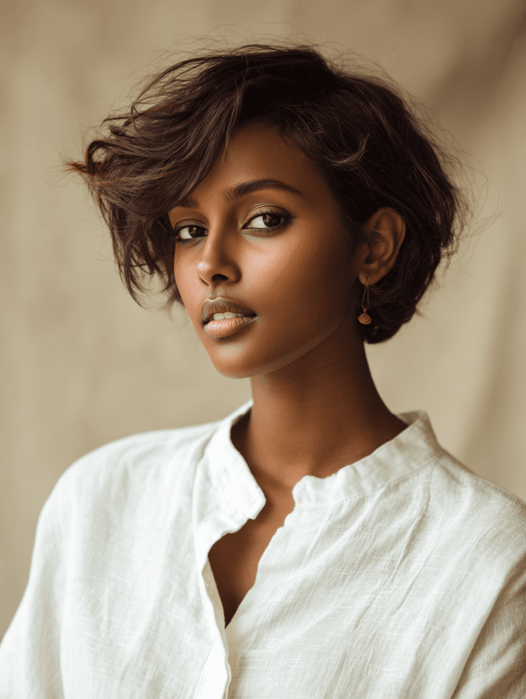 Portrait of a woman with short dark hair in a white shirt