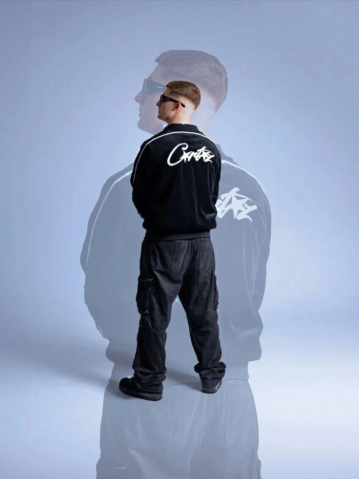 Double-exposure studio portrait of a man seen from behind in a black bomber jacket